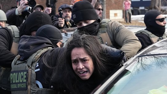 A protester is detained by Federal agents this month near the scene where Renee Good was fatally shot by an ICE officer.