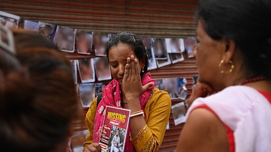 Champa Kumari Marchaha holds a photo of her husband Basanta Tharu who worked at the Tishuli Hydropower Station and has been missing since the flood. Champa still hopes that he is alive. those killed in Nepal flood disaster Kathmandu, Nepal. September 4,