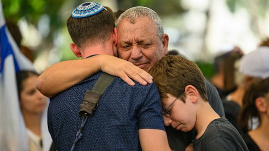 Former IDF chief Gadi Eizekon embraces family and friends at the funeral for his son Gal Meir Eisenkot, 25, in 2023.