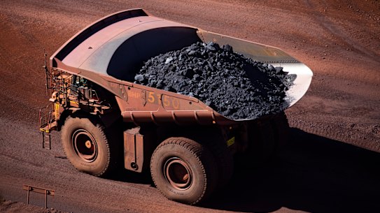 A loaded iron ore truck drives through the site at BHP Mt Whaleback Mine in Newman, Western Australia.
