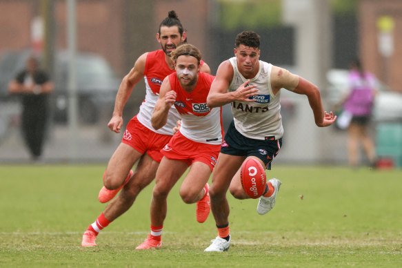 Finn Callaghan of the Giants chases the ball during the AFL practice match between Sydney Swans and Greater Western Sydney Giants.