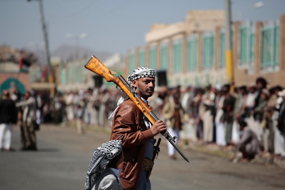 A Houthi supporter carries a rifle while attending an armed tribal rally in Sanaa this month.