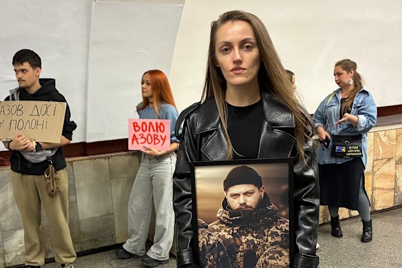 Natalie Kolodko, holding a photograph of her brother, Andriy, during a gathering in the Kyiv metro last month for the families of Ukrainian soldiers who are missing or held captive in Russia.