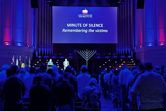 Attendees hold a minute’s silence for the Bondi victims at Brisbane City Hall on Sunday.