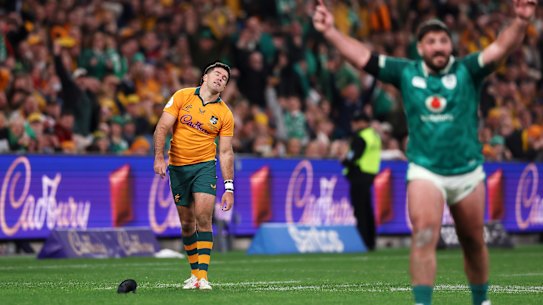 Ben Donaldson of the Wallabies looks dejected as Tom O'Toole of Ireland celebrates victory.