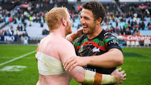  James Graham and Sam Burgess embrace after an NRL game.