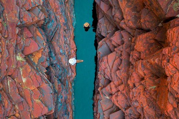 Dramatic red rocks and emerald pools of Weano Gorge at Karijini National Park.