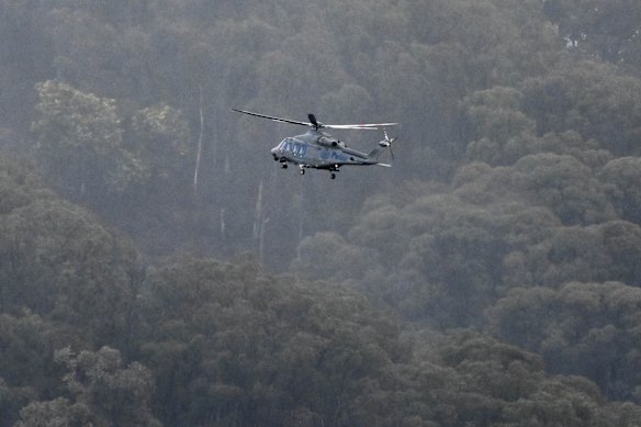 A helicopter searches through cloud in Porepunkah.