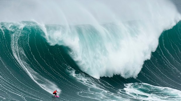  Maya Gabeira from Brazil rides a wave during the Nazare Big Wave Challenge surfing tournament at Praia do Norte in Portugal. Walsh headed further afield to find a more “manageable” wave to surf.