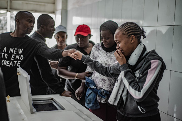Family members weep over the coffin of a two-year-old who was killed in an explosion during the fighting.