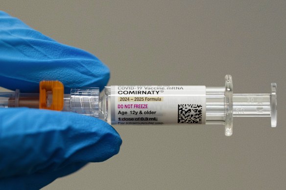 A pharmacist holds a Pfizer and BioNTech COVID-19 vaccine in Portland, Oregon, in April.