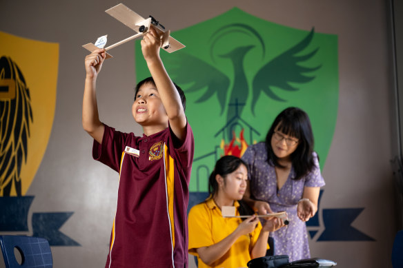 Christ the King Primary School teacher Quyen Thai with students Ethan (left) and Helen.