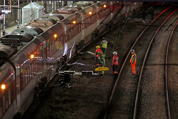 Emergency personnel inspect a train in Huntingdon station.