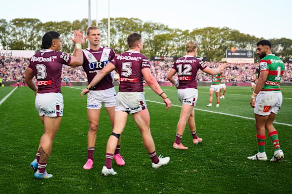Manly celebrate a try against Souths on Sunday.