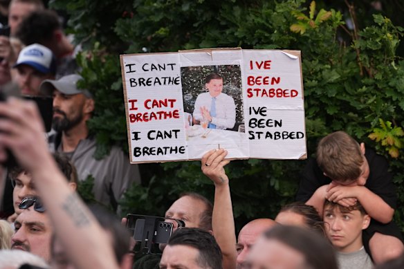 People protesting outside the police station in Southampton, England, on Tuesday, 