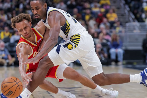 Dyson Daniels of the Atlanta Hawks and Aaron Nesmith of the Indiana Pacers battle for the ball during preseason.