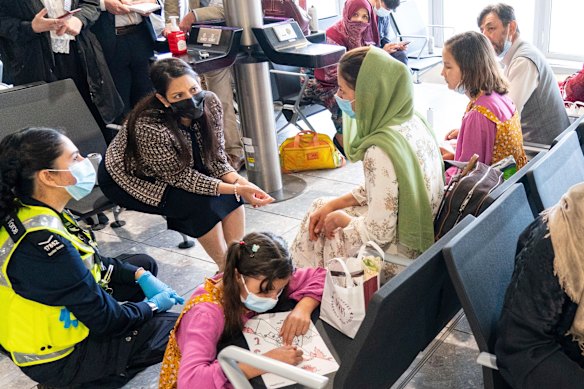 Then British home secretary Priti Patel, second form the left, talks Afghan refugees at Heathrow Airport in London in August 2021.