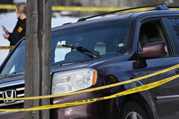 A bullet hole is seen in the windshield of a car at the scene of a fatal ICE shooting in Minneapolis.