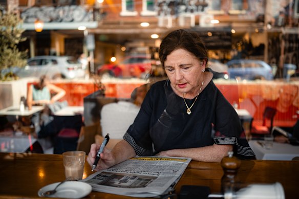 Julie Ruffy reading The Age at the famous window bench at the iconic Mario’s Cafe, Brunswick St, Fitzroy.