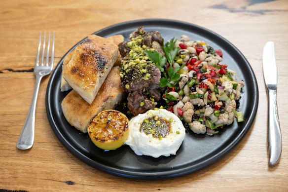 Slow-cooked lamb shoulder with labne and salad.