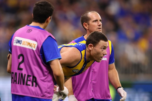 Jeremy McGovern looks on after a collision with the Demons’ Harrison Petty during the Eagles’ round eight clash at Optus Stadium.