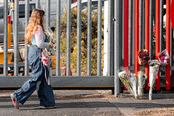Malika Carper left flowers at the Langs Rd, Melbourne Showgrounds gate where 3 men were hit by a car. She said the men may have even passed her stall yesterday. One man was killed and another is in a critical condition after leaving the Supanova festival last Saturday.