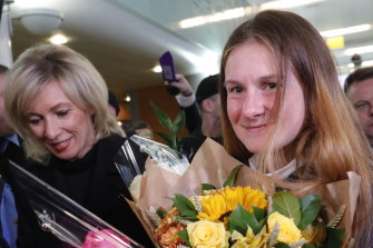 Maria Butina, right, returns to Russia after being deported from the States following her release from prison in October 2019. 
