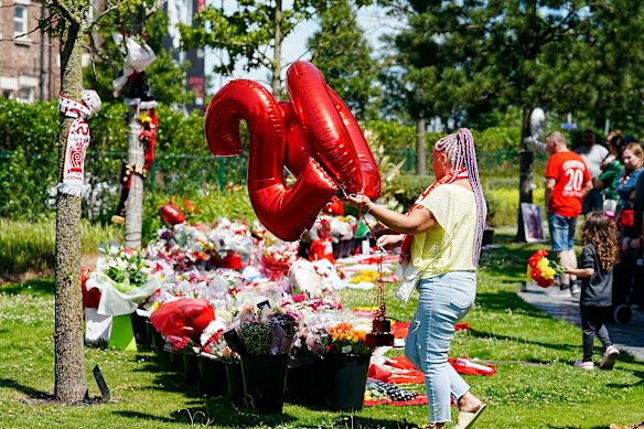A Liverpool fan leaves a tribute,