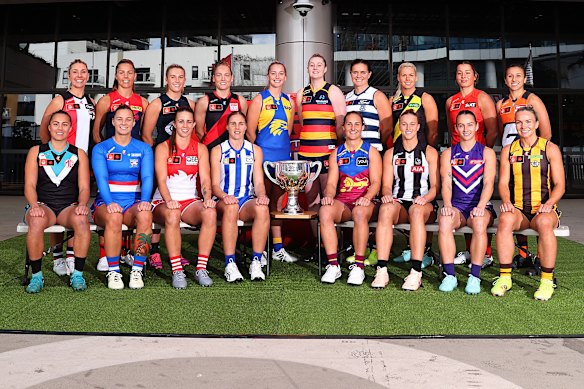 The AFLW captains pose with the premiership trophy on Tuesday ahead of the 2025 season.