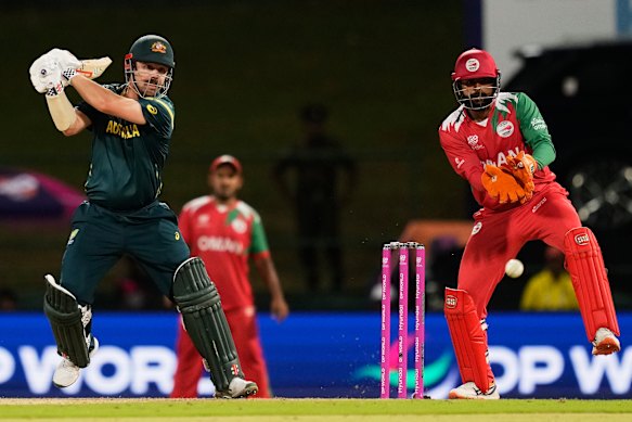 Travis Head plays a shot during the T20 World Cup cricket match against Oman.
