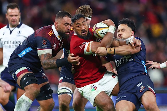 Bundee Aki of the British and Irish Lions is tackled by defenders during their game against the Queensland Reds.