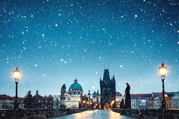 Charles Bridge in Prague on a snowy Christmas morning.
