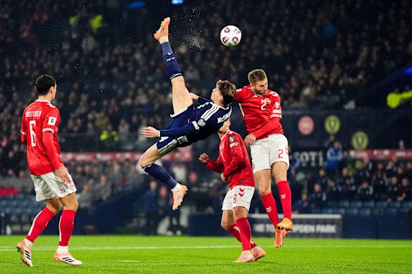 Scotland’s Scott McTominay scores the opening goal for Scotland with a bicycle kick.