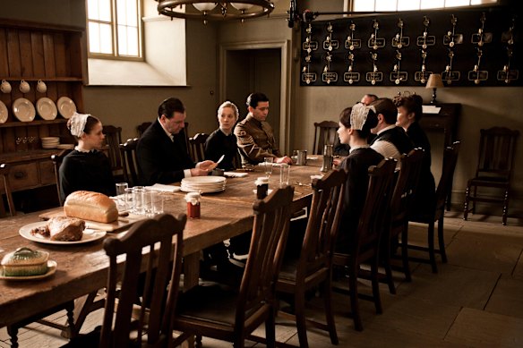 The bell wall, seen at the back of the room in a scene from Downton Abbey.