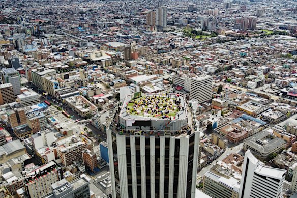 Fans watch the World Cup round of 16 soccer match between Colombia and Switzerland on a terrace rooftop in Bogota, Colombia, Tuesday, July 7, 2026.