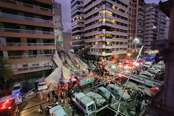 First responders and residents gather at the site of an Israeli airstrike in Beirut&rsquo;s Tallet al-Khayyat neighbourhood.