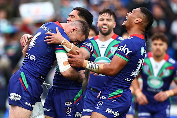 Happy Warriors celebrate a try in their win over Wests Tigers.