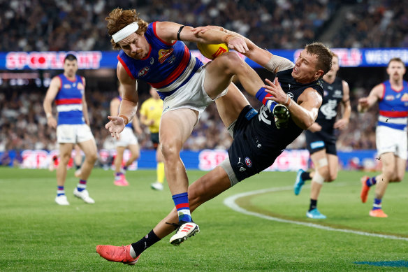 Patrick Cripps of the Blues and Oskar Baker of the Bulldogs in action.