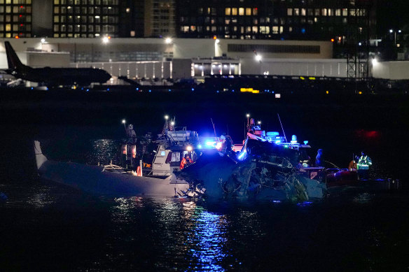 Emergency response units assess the wreckage in the Potomac River.
