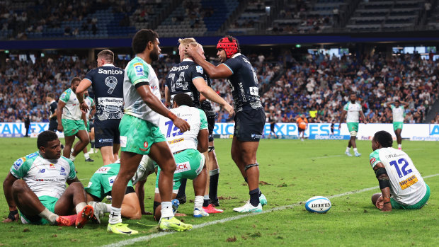 The Waratahs celebrate a Langi Gleeson try.
