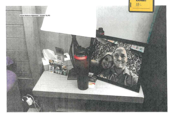 This image submitted as evidence shows a framed photo of Banfield and Magalhaes on a bedside table.