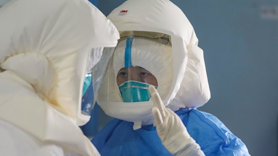 Medical staff work in the negative-pressure isolation ward in Jinyintan Hospital, designated for critical COVID-19 patients, in Wuhan.