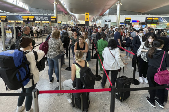 Travellers queue at Heathrow Airport which experienced significant demand over the July period. 