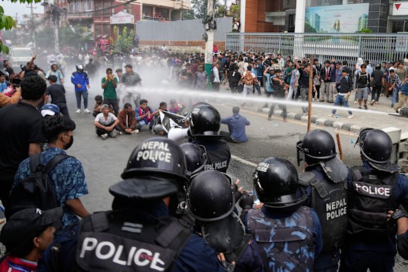 Riot police use a water cannon on protesters outside the parliament in Kathmandu on Monday.
