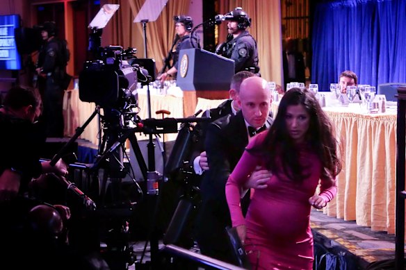 Homeland Security Advisor Stephen Miller and his wife, Katie, run from the ballroom.