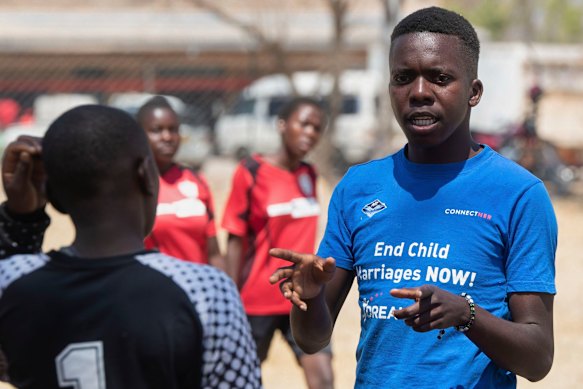 A soccer coach speaks to girls during the tournament.