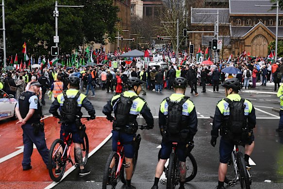 Police keep an eye on protesters at the march across the Harbour Bridge.