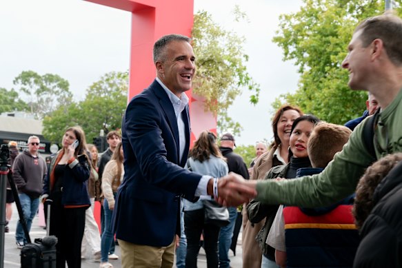 Malinauskas greets fans at the AFL match between the Adelaide Crows and the Carlton Blues at Adelaide Oval in April.