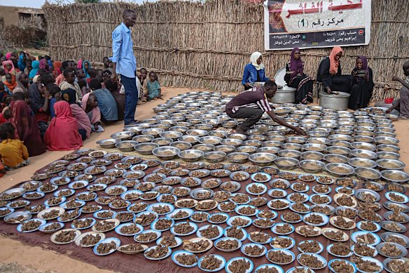 Sudanese volunteers prepare free meals for residents of El Fasher on August 11.