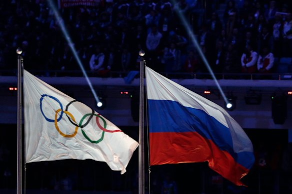 The Russian flag flies next to the Olympic flag at the closing ceremony of the 2014 Winter Games in Sochi.